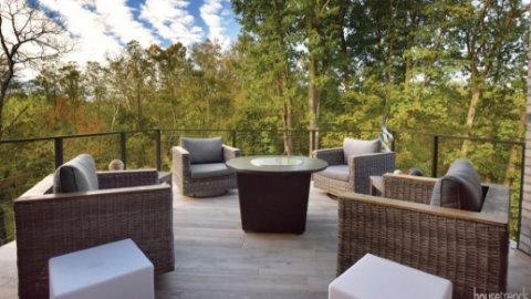 Wooden outdoor patio with railings and furniture